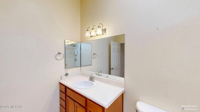 bathroom featuring toilet, walk in shower, and vanity