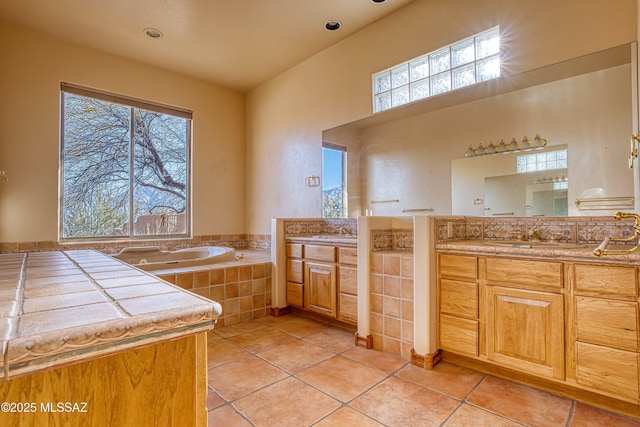 bathroom with tile patterned floors, a healthy amount of sunlight, and vanity