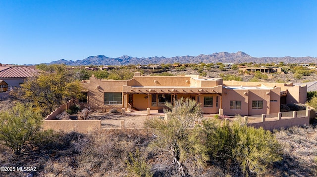 rear view of house featuring a mountain view and a patio