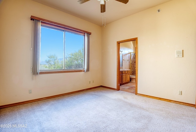 unfurnished room featuring ceiling fan and light colored carpet