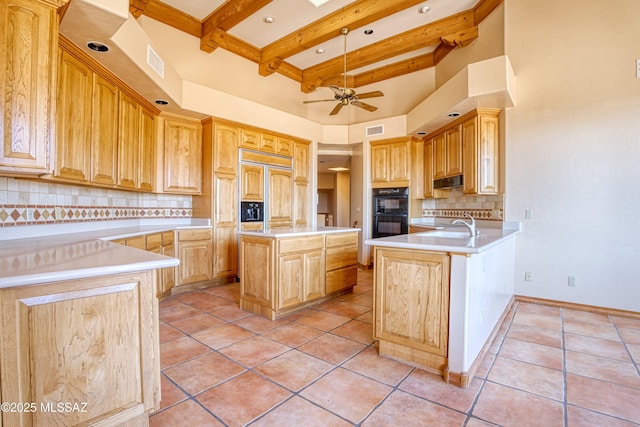 kitchen with beamed ceiling, an island with sink, hanging light fixtures, light tile patterned floors, and ceiling fan