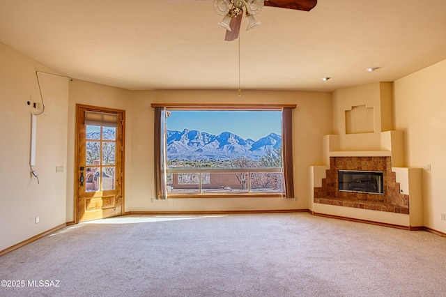 unfurnished living room with ceiling fan and carpet floors