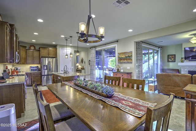 dining room featuring sink and a notable chandelier