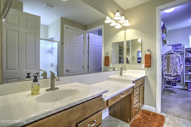 bathroom with vanity, tile patterned flooring, and walk in shower