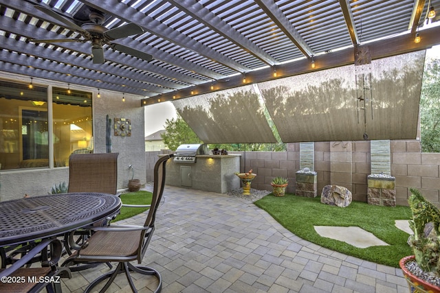 view of patio with an outdoor kitchen, grilling area, and a pergola