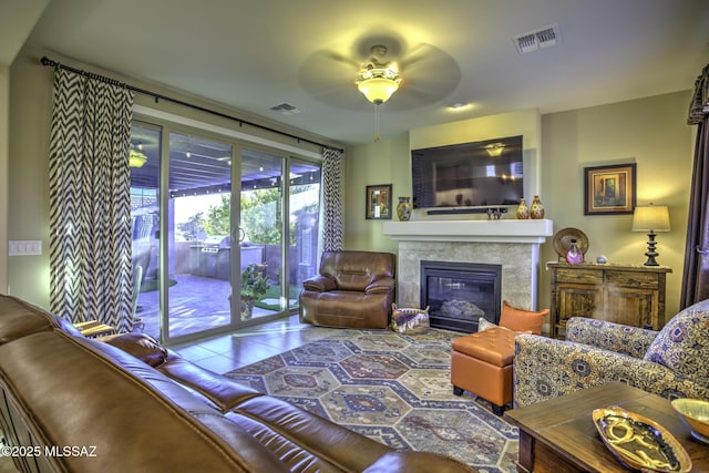 living room featuring tile patterned flooring and ceiling fan