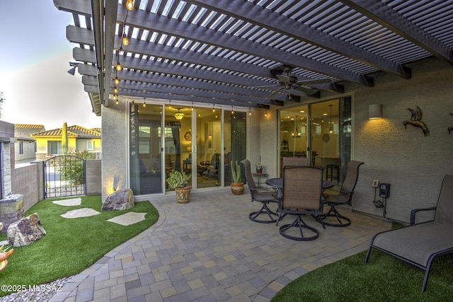 view of patio / terrace with ceiling fan and a pergola