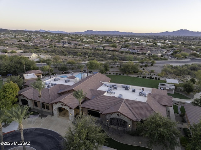 aerial view at dusk featuring a mountain view