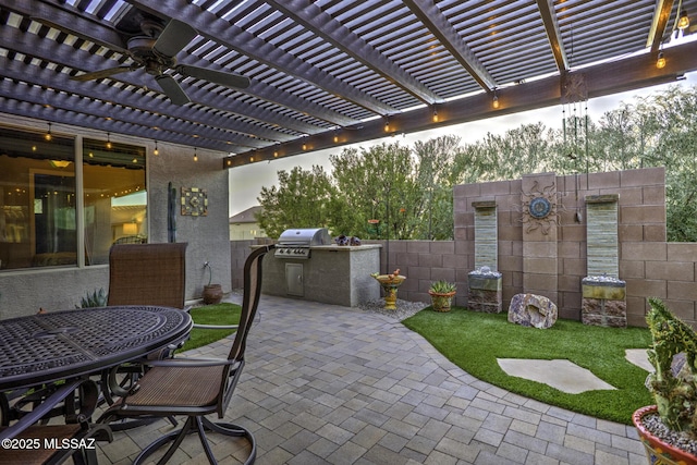 view of patio featuring ceiling fan, an outdoor kitchen, a pergola, and area for grilling