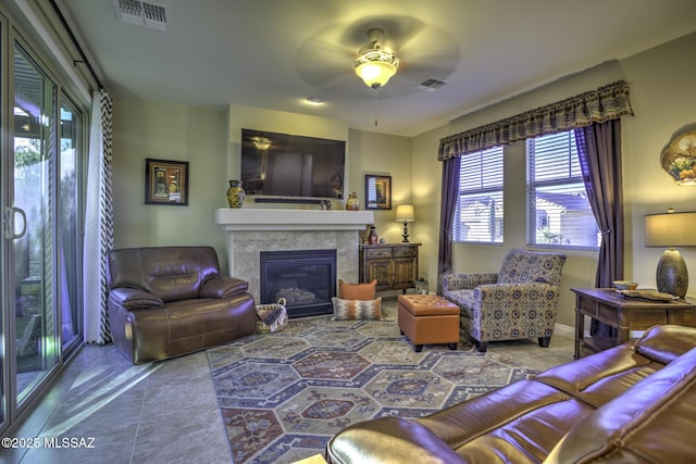 living room featuring tile patterned flooring and ceiling fan