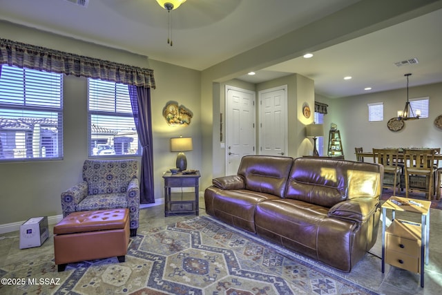 living room featuring tile patterned floors and a chandelier