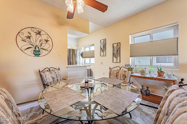 living room with ceiling fan and a textured ceiling