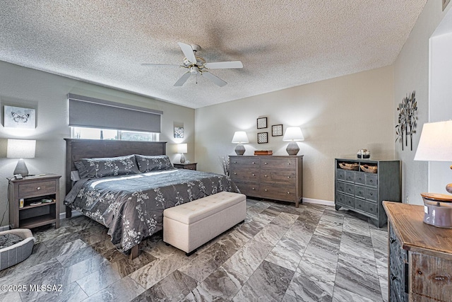 bedroom with ceiling fan and a textured ceiling