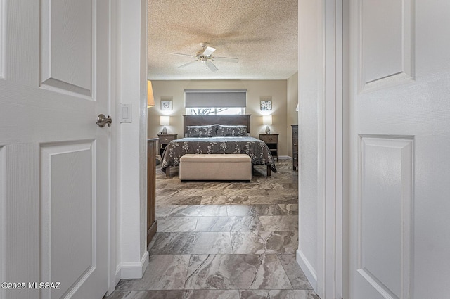 bedroom featuring ceiling fan and a textured ceiling