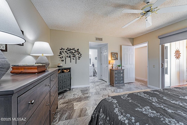 bedroom featuring ceiling fan and a textured ceiling