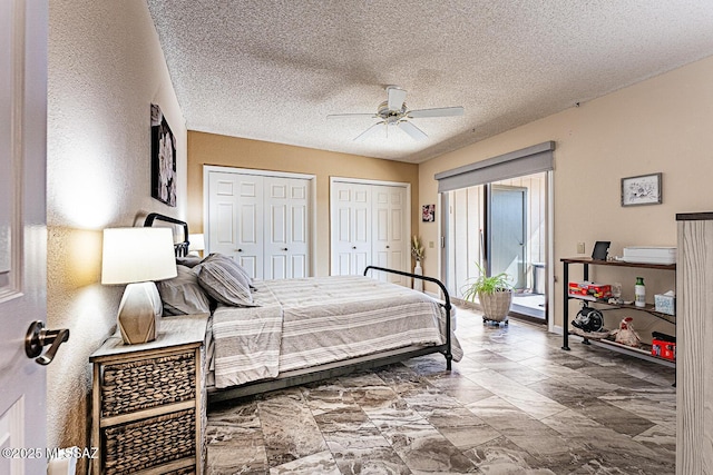 bedroom featuring multiple closets, ceiling fan, access to exterior, and a textured ceiling