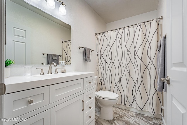 bathroom with vanity, a shower with shower curtain, and toilet
