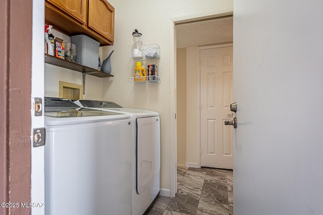 laundry room with cabinets and washing machine and clothes dryer