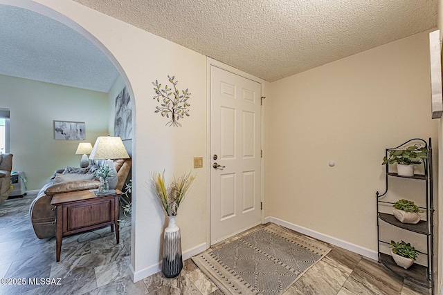 foyer entrance featuring a textured ceiling