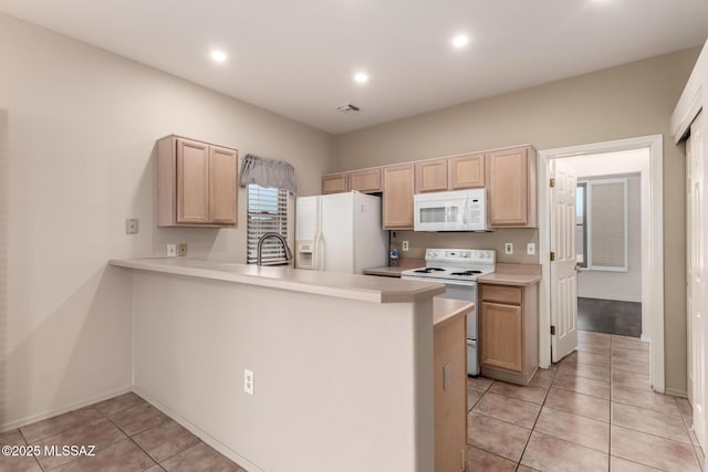 kitchen with light brown cabinetry, white appliances, kitchen peninsula, and light tile patterned flooring