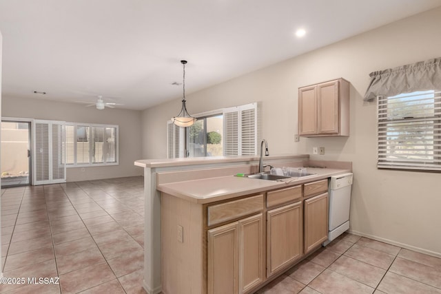 kitchen featuring white dishwasher, sink, kitchen peninsula, and light brown cabinets