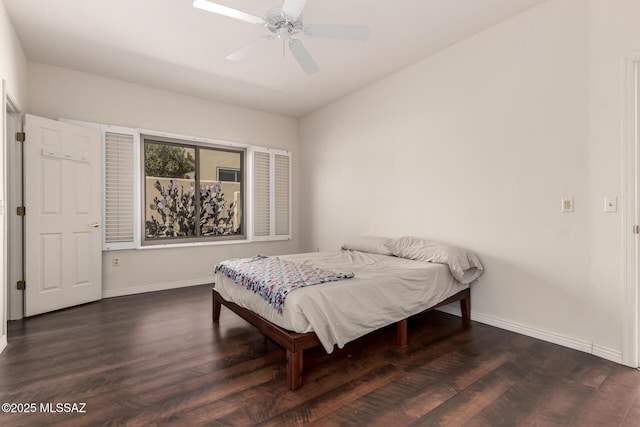 bedroom with ceiling fan and dark hardwood / wood-style flooring