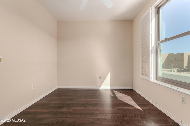 empty room with dark hardwood / wood-style floors and ceiling fan