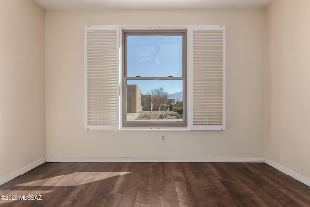 spare room featuring dark hardwood / wood-style flooring
