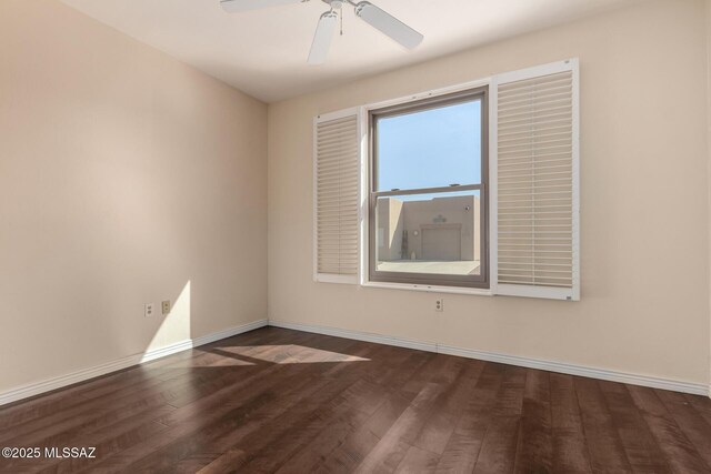 empty room with dark hardwood / wood-style floors and ceiling fan