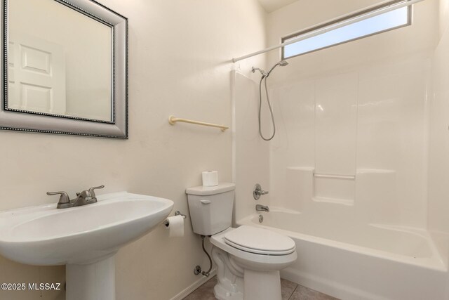full bathroom featuring bathtub / shower combination, sink, tile patterned floors, and toilet