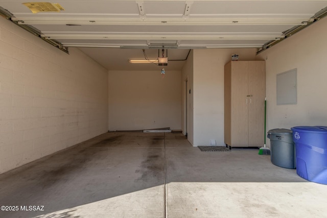 garage featuring a garage door opener and electric panel