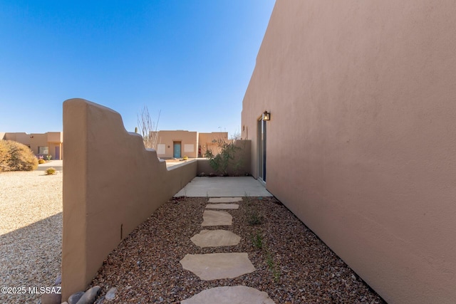 view of side of property featuring a patio