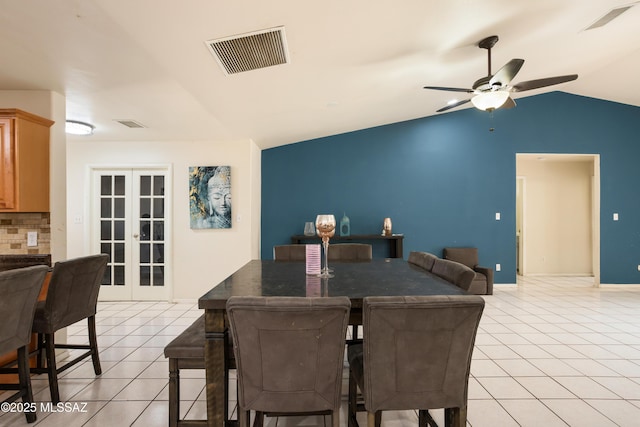 tiled dining room with lofted ceiling, french doors, and ceiling fan