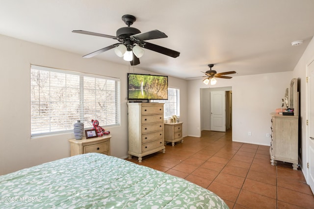 tiled bedroom featuring ceiling fan