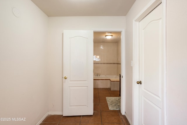 corridor with dark tile patterned flooring