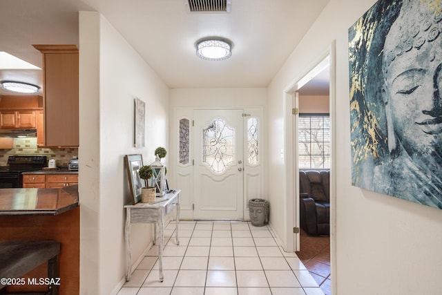 foyer featuring light tile patterned floors