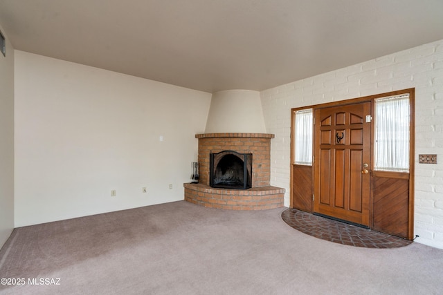 unfurnished living room featuring carpet floors and a fireplace