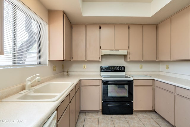 kitchen featuring cream cabinets, sink, light tile patterned floors, and black range with electric cooktop