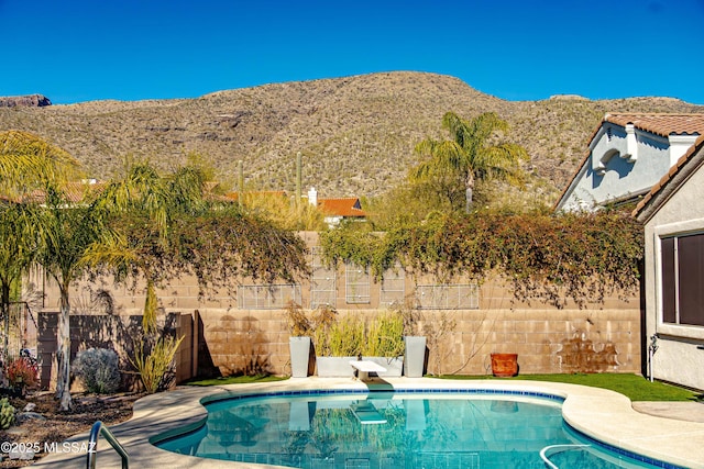 view of pool featuring a mountain view and a diving board