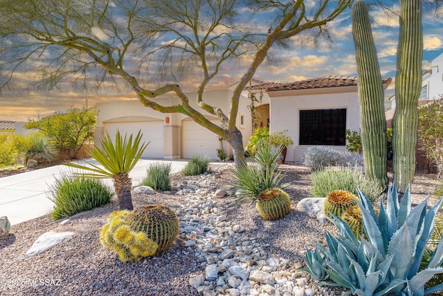 mediterranean / spanish-style home with a garage