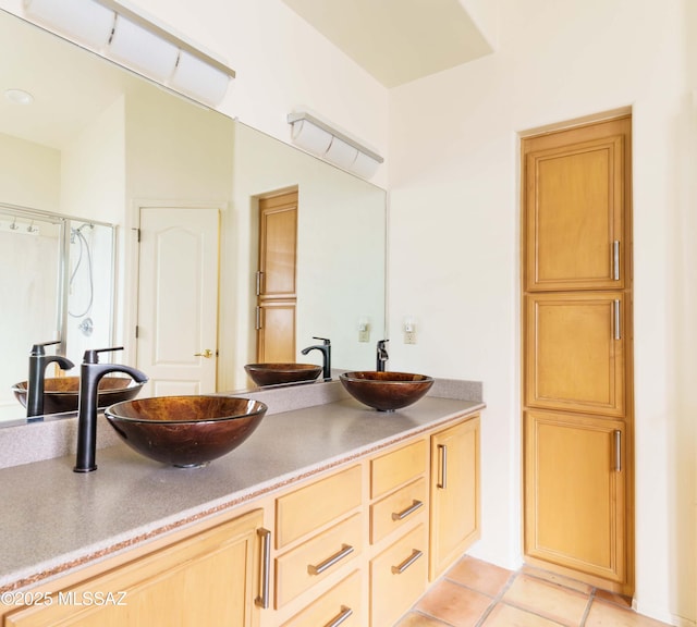 bathroom featuring tile patterned floors, vanity, and an enclosed shower