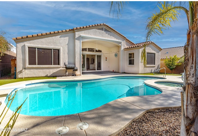 back of house with a fenced in pool and a patio