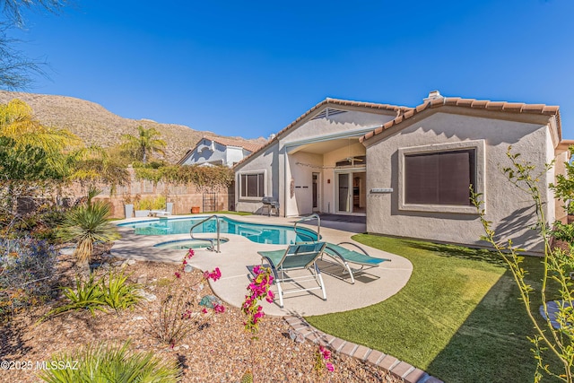 view of swimming pool featuring a mountain view, a patio, and a lawn