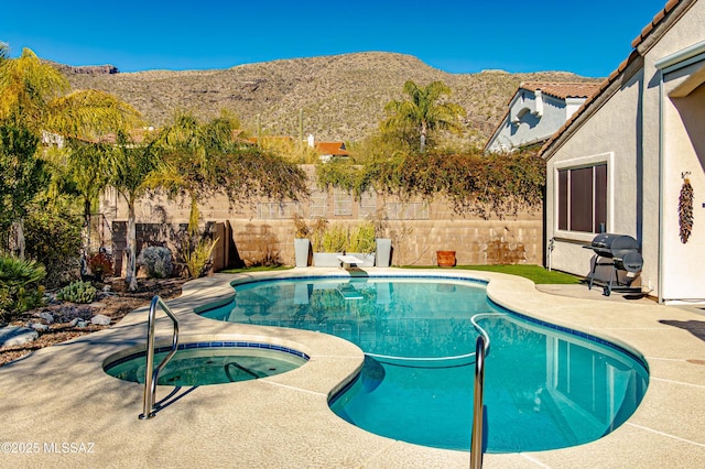 view of pool featuring a mountain view, grilling area, and an in ground hot tub