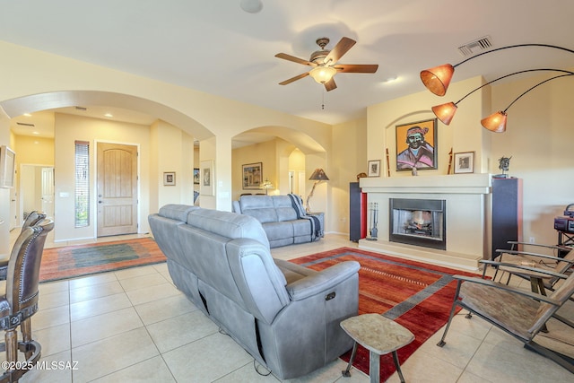 tiled living room featuring ceiling fan