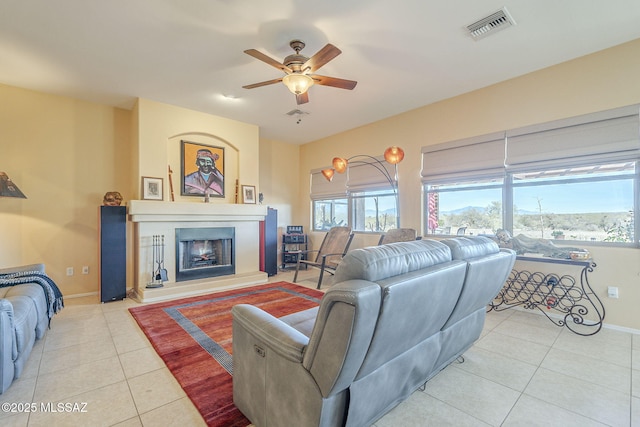 living room featuring light tile patterned flooring and ceiling fan