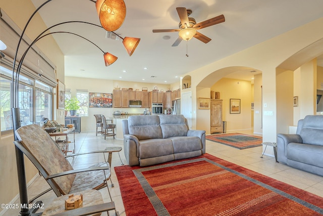 tiled living room with ceiling fan