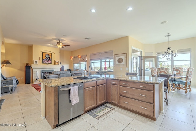 kitchen featuring pendant lighting, sink, a wealth of natural light, a center island with sink, and stainless steel dishwasher