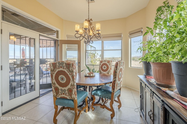 tiled dining area featuring a notable chandelier