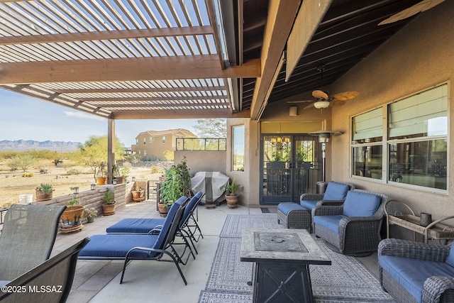 view of patio / terrace with a grill, an outdoor living space with a fire pit, ceiling fan, and a pergola